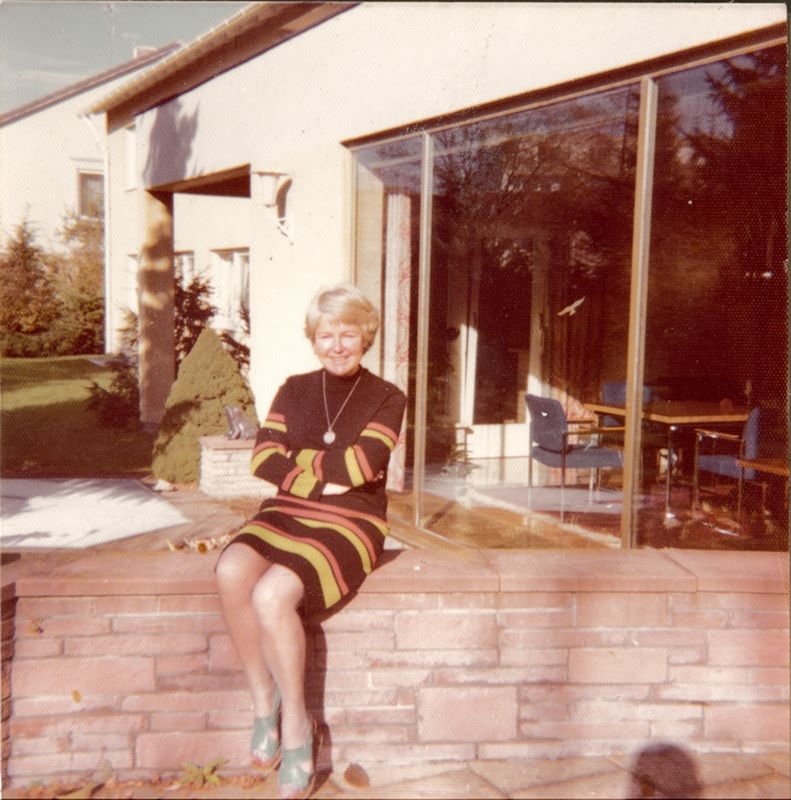 Aunt Christa on the terrace in front of the office - Background: office of the director (Lo?) - November 1974 - The shoes were not supposed to come along but they are comfortable.